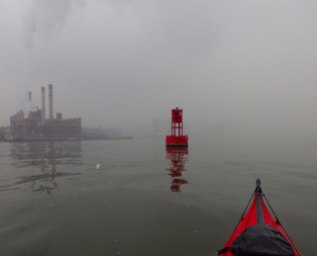 We paddle to the red buoy in the middle of the East River