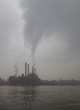 Power plant steam rises across the river