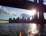 Clouds and sun under the Manhattan Bridge
