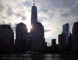 The sun peeks out from behind the new World Trade Center tower